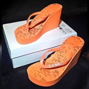 Size 9 rare pumpkin orange Bebe wedge thong sandals